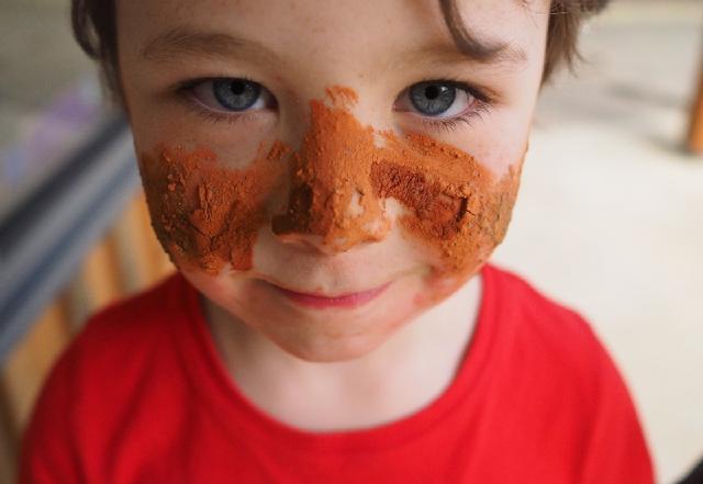 A child with dirt on their face